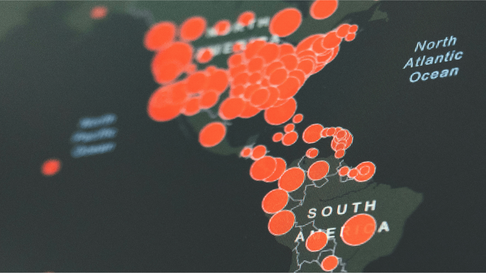 Map of North and South America with clusters of red circles indicating data points or hotspots.